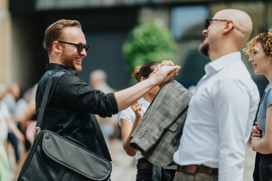 Two male colleagues greet each other with a handshake and smiles on a busy city street. Friends and coworkers meet outdoors for a friendly urban networking moment.