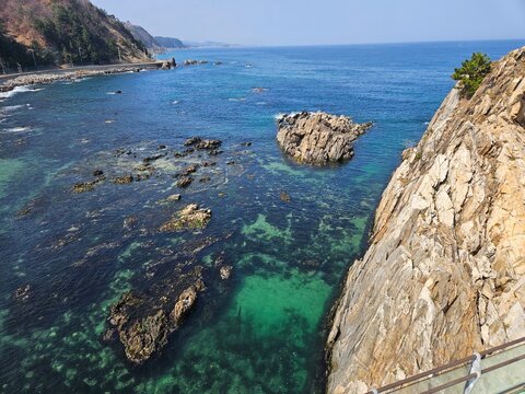 Cliff and emerald cove with clear water along the coast of Yangyang, Korea