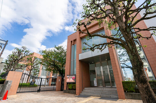 NAKANO-KU, TOKYO, JAPAN - OCTOBER 3, 2026: Exterior facade of the school building with brick-style tiles at Toa Gakuen High School in Nakano-ku, Tokyo.