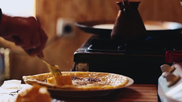 The process of making Traditional Balkar khychin, a thin stuffed flatbread from the North Caucasus, being prepared and cooked in a kitchen in slow motion video. Balkar cuisine and traditional food..