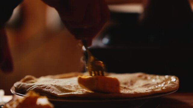 The process of making Traditional Balkar khychin, a thin stuffed flatbread from the North Caucasus, being prepared and cooked in a kitchen in slow motion video. Balkar cuisine and traditional food..