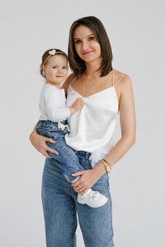 Smiling Mother Embracing Her Small Child Standing