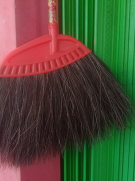 red broom and green tools of sweep cleaner