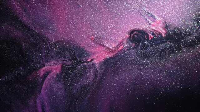 Silver spark dust drifts through a sweeping wave of pink ink over a black plate, creating a slow, space-like abstract texture.