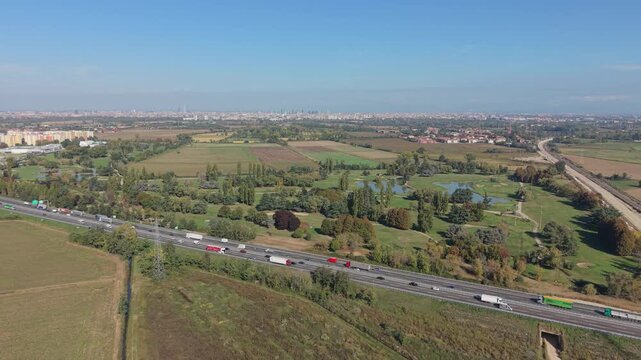 Aerial view of dense vehicle traffic moving along a major highway in Milan, Italy, forming part of a key transport corridor.