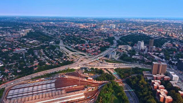 Approaching a large rail yard facility used for servicing subway cars. Numerous cars move by the Kew Gardens Interchange in Queens, New York City.