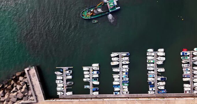 Cand&aacute;s marina aerial top-down symmetrical pattern of floating docks and parked leisure boats, Asturias, Northern Spain