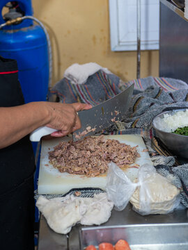 Female Hands Cutting Meat at a Traditional Mexican Taco Stand