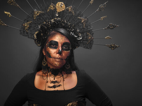 Studio Portrait of a Woman in Catrina Costume and Makeup on Dark Background