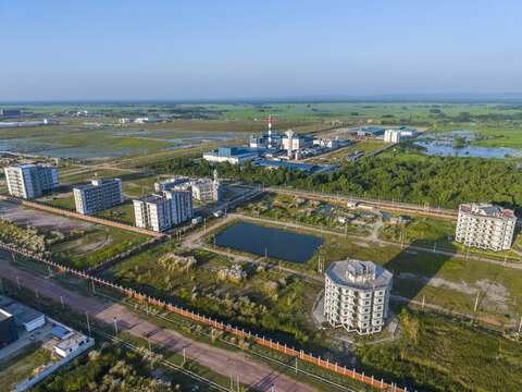 Aerial view of Mirsarai Economic Zone featuring industrial facilities, modern residential buildings, a central pond, and surrounding green landscapes in Minsarai, Chittagong Division, Bangladesh.