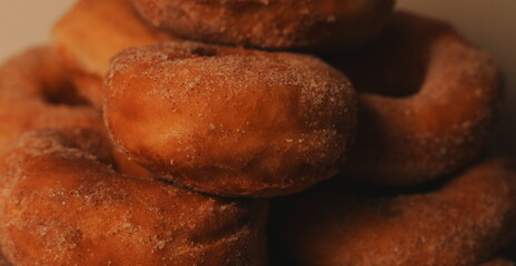 Golden Brown Sugar Dusted Ring Donuts Piled High Homemade Freshly Baked Textured Surface Inviting Warm Background © lumerb