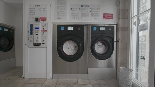 Laundromat washing machines in coin laundry, Italy