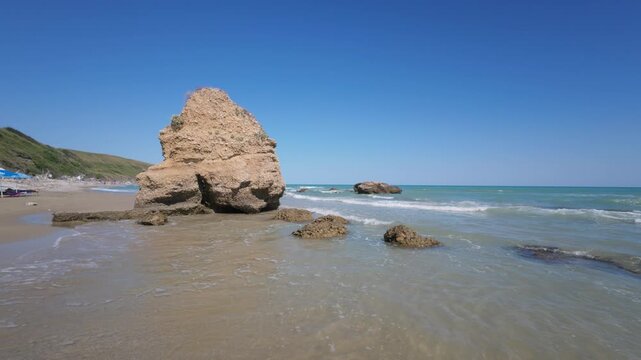 Rough sea waves crashing on rocks, Italy