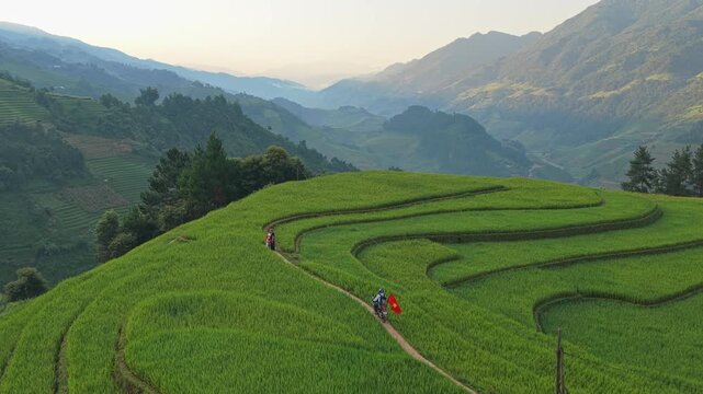 Motorbike carrying vietnamese flag riding through mu cang chai rice terraces