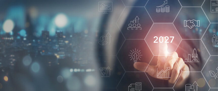 2027 Business Outlook. Strategic Growth, touching a glowing 2027 digital interface with icons,  business strategy, financial growth, innovation, investment and future opportunities.
