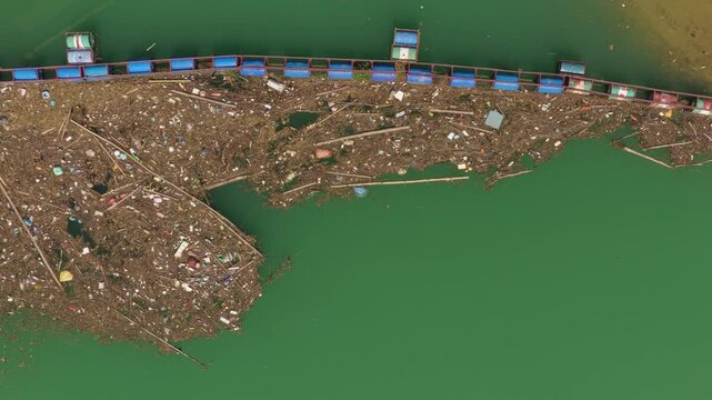 Aerial view of massive floating garbage patch in a river