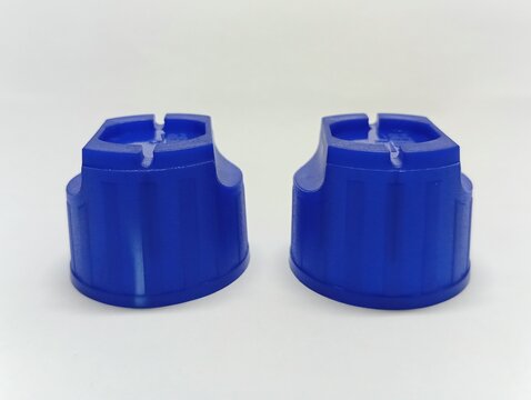 Blue plastic cap with white mark stress defect from undercut core insert - injection molding quality control