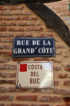 Albi, France street sign. Rue de la Grand Cote or Costa del Bus - bilingual sign in French and Occitan language.