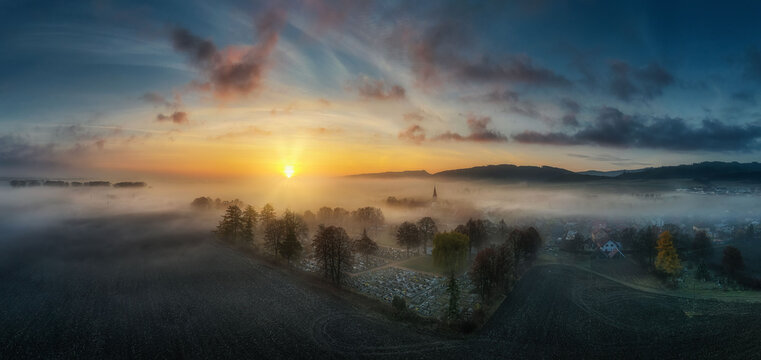 Autumn nature at sunrise in the fog