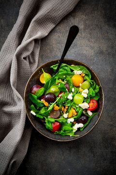 Fresh late summer salad features baby spinach, tomato and feta