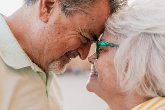 Senior couple shares a tender moment of love outdoors