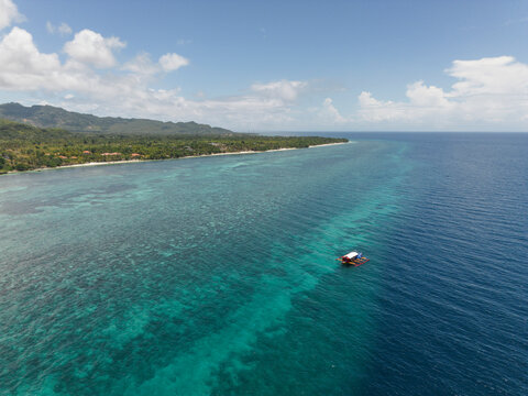 Aerial view of coral reef and boat in Anda Bohol Philippines