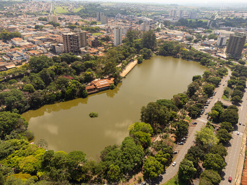 Aerial view of Parque Municipal Fabio da Silva Prado - Lago Municipal, featuring a large lake surrounded by lush green trees and park paths in Araras, Sao Paulo, Brazil.