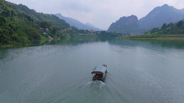 Traditional touristic boat navigating the bac mei river in vietnam