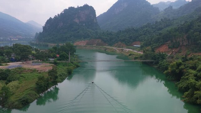 Aerial view of motorboat cruising along river in bac me vietnam