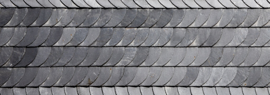 grey slate roof tile texture background with rounded scale pattern