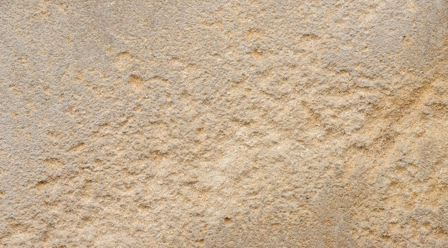 rough beige sandstone wall texture background