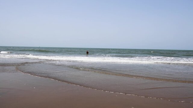 Man Enjoying A Refreshing Seaside Break running and bathing On A Sunny Coastal Beach