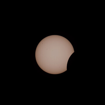 Early Partial Solar Eclipse With Sunspots on Black Sky