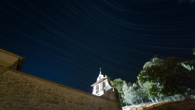 Stone Church Beneath Diagonal Star Trails at Night