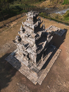 Aerial view of the ancient Gedong Songo Temple surrounded by terraced fields and lush landscape in Bandungan, Jawa Tengah, Indonesia.