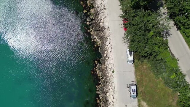 Aerial Top Down View of Rocky Coastline Turquoise Sea Water and Road