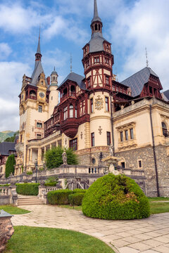 Peles Castle facade with decorative towers carved wooden balconies and stone terraces in Sinaia Romania