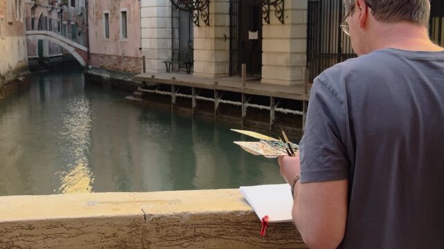 Artist Sketching Beside a Quiet Venetian Canal