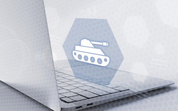 Imagen conceptual de un ordenador port&aacute;til con icono de tanque en un hex&aacute;gono flotante, simbolizando videojuegos de guerra, estrategia digital y tecnolog&iacute;a militar moderna.