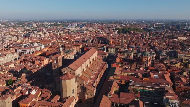 Aerial drone view of Basilica di San Petronio in Bologna, Italy, showcasing its monumental fa&ccedil;ade, historic architecture, Piazza Maggiore, and surrounding old town cityscape.