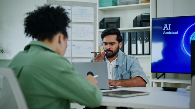 Modern Indian businessman speaking to smartphone voice assistant using AI agent technology for office workflow automation, smart communication, digital workspace efficiency and corporate business