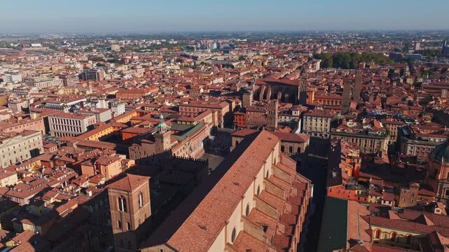 Aerial drone view of Basilica di San Petronio in Bologna, Italy, showcasing its monumental fa&ccedil;ade, historic architecture, Piazza Maggiore, and surrounding old town cityscape.