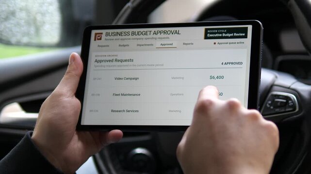 Executive reviews a budget approval report on a tablet in a car, capturing real-time spending oversight, mobile finance control and agile decision making across departments.