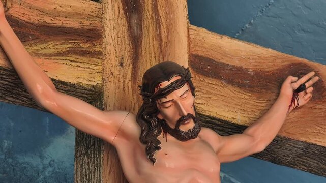 Footage of the statue of the crucified Lord Jesus, Detail and close up of the statue of Jesus' face. Jesus crucified