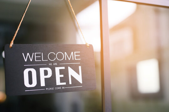 Welcome open sign on shop door. Text on cafe front or restaurant hang on door at entrance. vintage tone style. banner.	
