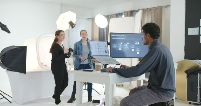 Diverse team after studio setup showing camera to lead checking Brand Check for crop, copy space