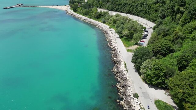 Aerial Top Down View of Rocky Coastline Turquoise Sea Water and Road