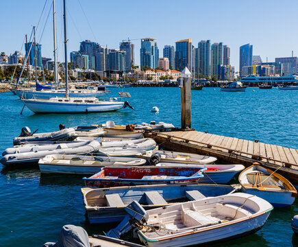 Several Dinghies at The Small Boat Dock With Sailboats Moored Across San Diego Bay and Downtown in The Distance, San Diego, California, USA