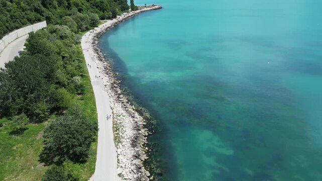 Aerial Top Down View of Rocky Coastline Turquoise Sea Water and Road