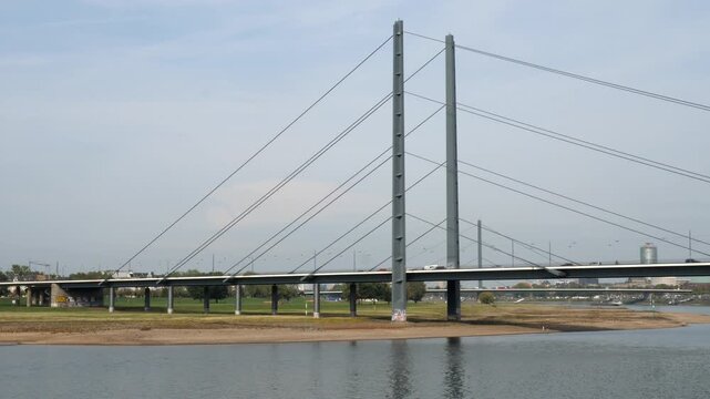Modern Cable Stayed Bridge Crossing River Rhine in European City Infrastructure Architecture Traffic Transportation Concept Wide Angle Daytime Video